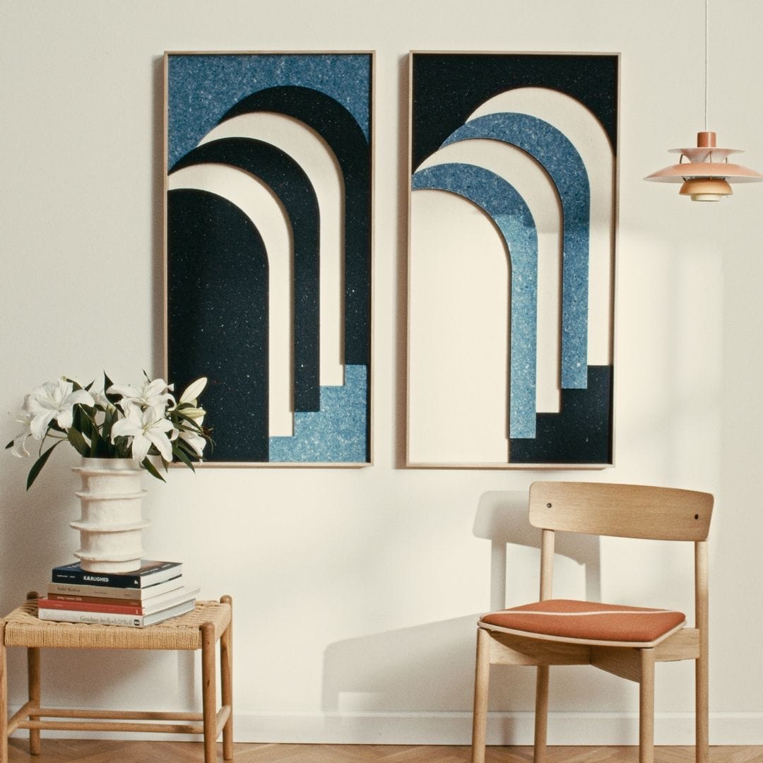 New modern art panels in blue and white with arch designs, adding style and acoustic enhancement to living room decor.