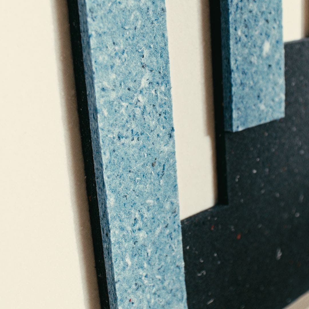 Close-up of eco-friendly acoustic panels by Arturel, crafted from sustainable blue and black materials for sound absorption.